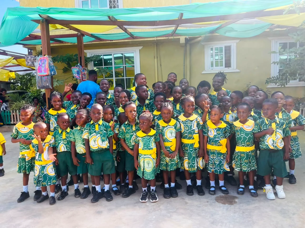 ASMA pupils posing together in front of the school building
