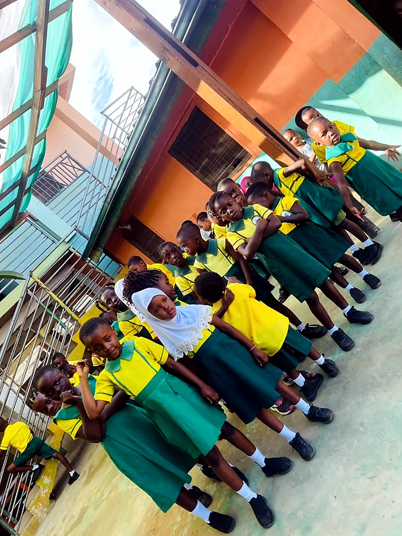 Young ASMA pupils assembled in the colourful school courtyard
